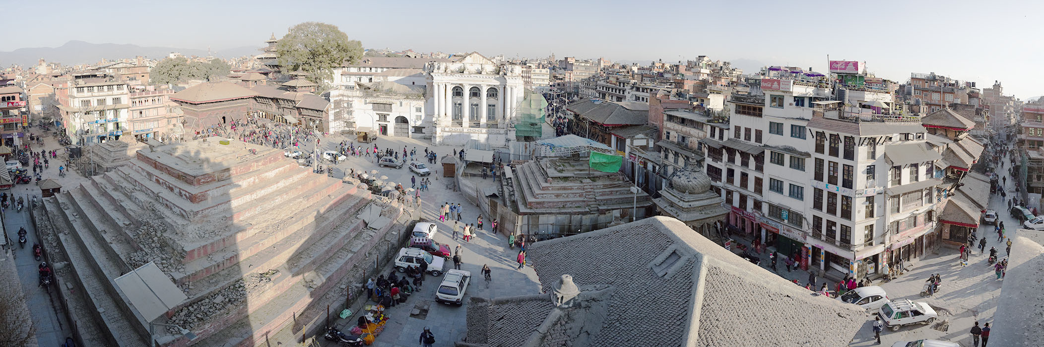 Very Wide Panorama of Traditional Nepali City Center with Vibrant Daily Life and Earthquake Damage.